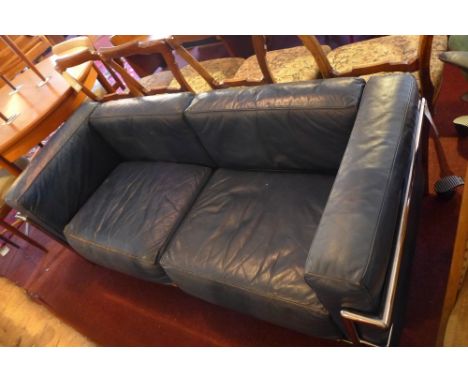 A Le Corbusier style Cassina three seater sofa with blue leather cushions and chrome supports.