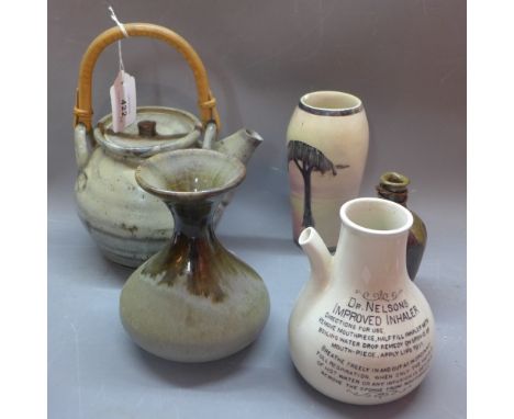 A studio pottery teapot together with two studio pottery vases and two other vases.