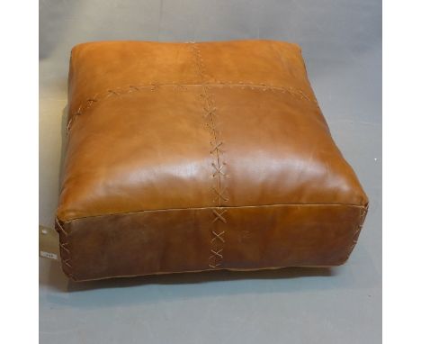 A contemporary brown leather pouffe 