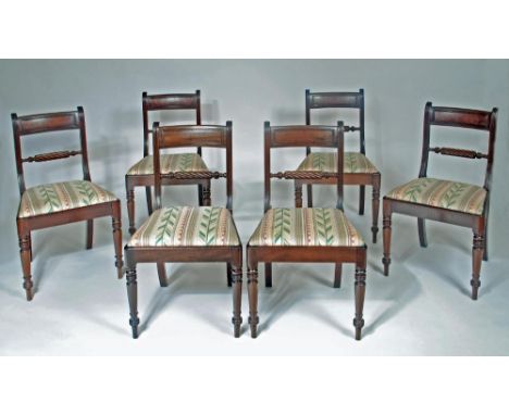 A SET OF SIX REGENCY MAHOGANY DINING CHAIRS, the shaped reeded uprights enclosing top rail with reeded panel over a rope twis