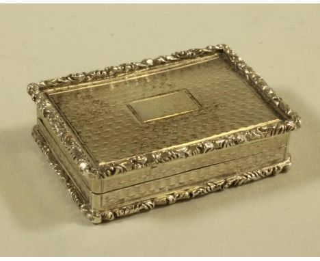 A WILLIAM IV SILVER VINAIGRETTE, maker's mark T.L., Birmingham 1835, of plain oblong form with applied foliate chased rims en