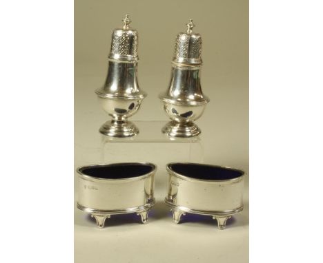 A PAIR OF SILVER SALTS, makers Haseler & Haseler, Chester 1913, of plain oval form, raised upon four peg feet, 2 3/4" wide, w
