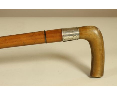 A MALACCA SWORD STICK, c.1900, with 26 ½" double edged blade, hardwood crooked handle and white metal ferrule with engraved i