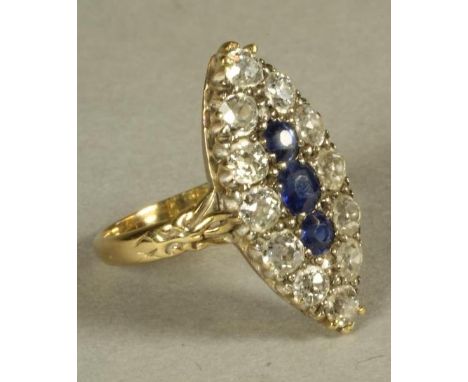 A SAPPHIRE AND DIAMOND DRESS RING, the three facet cut sapphires horizontally set within a border of twelve old brilliant cut