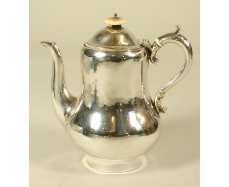 AN EARLY VICTORIAN BRITANNIA STANDARD SILVER HOTWATER JUG, maker R. Garrard, London 1851, of baluster form, the hinged domed 