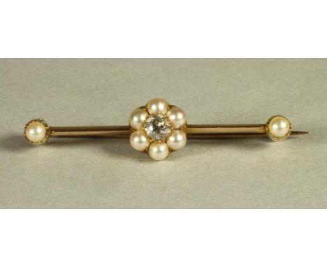 A LATE VICTORIAN 15CT GOLD BAR BOOCH, the knife edge bar centred by a diamond and pearl cluster with a pearl at each end