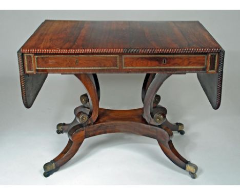 A REGENCY ROSEWOOD SOFA TABLE, early 19th century, with gilt metal mounts, reel edged rounded oblong top over similarly edged