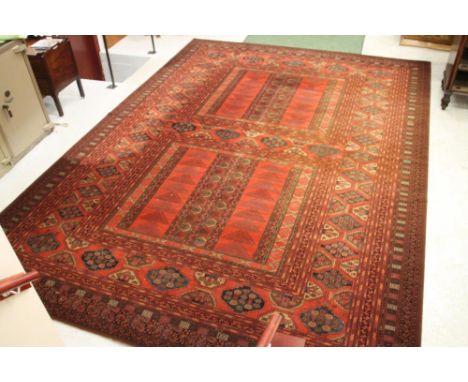 AN AFGHAN STYLE CARPET, 20th century, of Purdah design, machine made, the field in panels each with vertical elements, featur