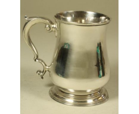 A GEORGE II SILVER MUG, maker Humphrey Payne, London 1742, of plain baluster form on a low spreading foot and with earred dou