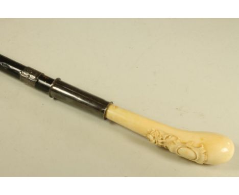 A  VICTORIAN SWORD STICK, with 4" spear point blade, ivory knob grip bearing carved vacant baroque shield with floral swag, l