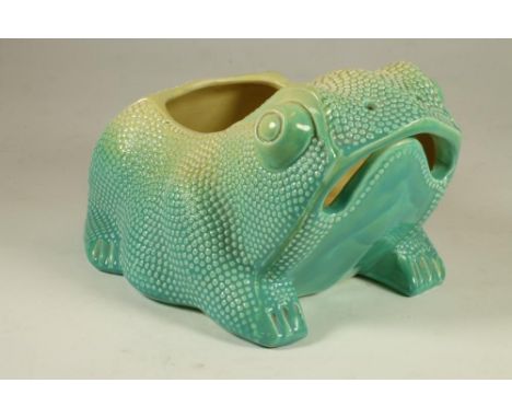 AN ARTS AND CRAFTS FAIENCE TOAD PLANTER, the grotesque amphibian with open mouth and pierced nostrils in a sea green shading 