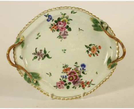 A FIRST PERIOD WORCESTER PORCELAIN DESSERT DISH, c.1770, of quatrefoil form with two twig handles, painted in polychrome enam