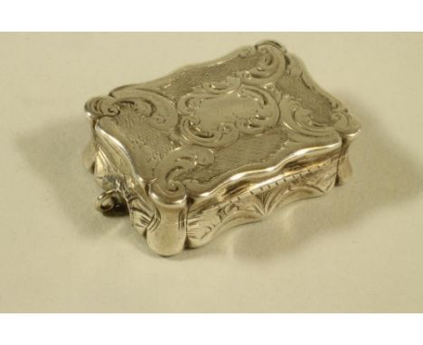 AN EARLY VICTORIAN SILVER PENDANT VINAIGRETTE, maker Edward Smith, Birmingham 1851, of shaped oblong form bright cut engraved