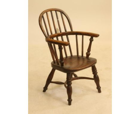 A CHILD'S ASH AND ELM WINDSOR ARMCHAIR by F. Walker, Rockley, of double hoop stick back form with baluster turned arm support