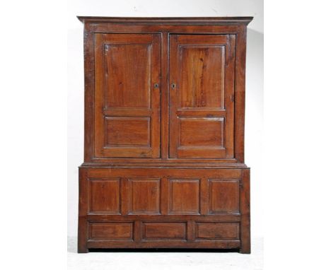 AN OAK LIVERY CUPBOARD, early/mid 18th century, the moulded cornice over two twin fielded panel doors opening to interior wit