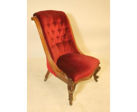 A VICTORIAN WALNUT FRAMED PARLOUR CHAIR of Grecian form, button upholstered in red velvet, channelled frame, serpentine front