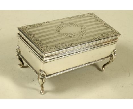 A SILVER DRESSING TABLE BOX, maker's mark HM, Birmingham 1914, of plain oblong form, raised upon four cabriole supports, the 