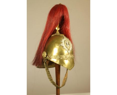 A VICTORIAN BRASS HELMET OF THE 1ST (KINGS) DRAGOON GUARDS, with ear to ear wreath, top mount and spike, Dragoon badge to cen