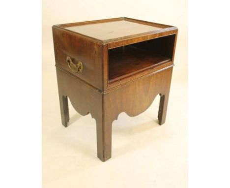 A GEORGIAN MAHOGANY BEDSIDE CABINET, c.1750, of oblong form with dished moulded edged top, the fascia with open shelf over pu