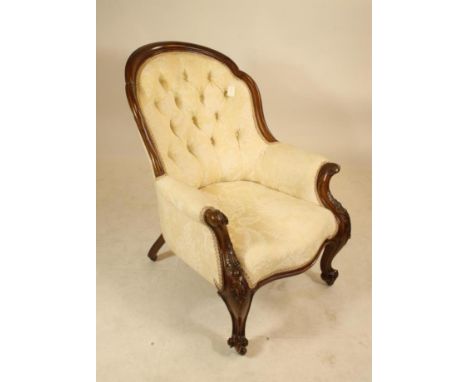 A VICTORIAN MAHOGANY ARMCHAIR, button upholstered in cream and white floral damask, the arched back with cusped and channelle
