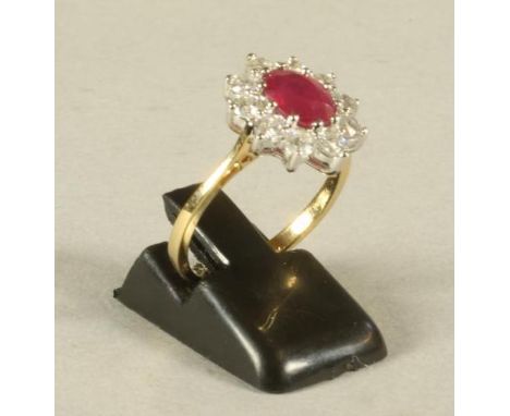 A RUBY AND DIAMOND CLUSTER RING, the oval cut ruby claw set to a border of ten brilliant cut diamonds to a plain 18ct gold sh