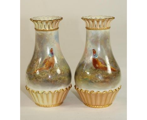 A PAIR OF ROYAL WORCESTER CHINA SMALL VASES, 1904, of baluster form with arcade pierced rims, painted in polychrome enamels b