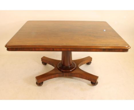 A WILLIAM IV ROSEWOOD BREAKFAST TABLE, the rounded oblong tip up top with plain frieze, raised on plain turned tapering stem 