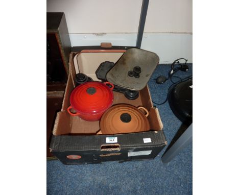 Two Le Creuset cooking pots and a set of scales with weights