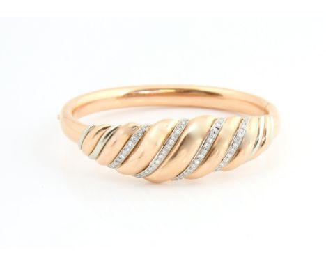 Gold hinged bangle of ribbed design, set with lines of diamonds, marks for 14 ct gold, internal width 6.1 cm.     CONDITIONOv