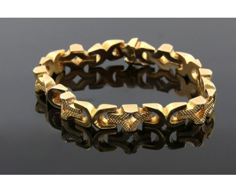Vintage gold bracelet, with cross shaped, alternately textured links, concealed clasp, figure of eight safety catch, 18.5cm i