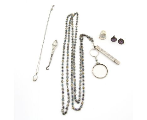 Guard chain in white metal, the floral links with enamel centres,clasp holding cased pencil and eye glass, moonstone pendant,