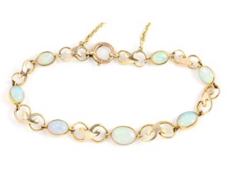 Opal bracelet, seven oval cabochon cut opals rub over set, scrolled fancy links alternately set, with bolt ring clasp and saf