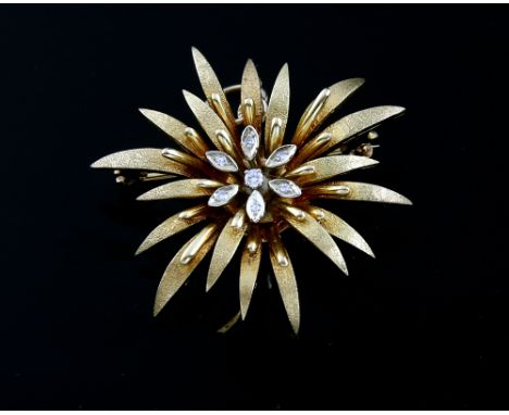 Vintage floral brooch, centrally set with one round brilliant cut diamond, surrounded by six Swiss cut diamonds, above textur
