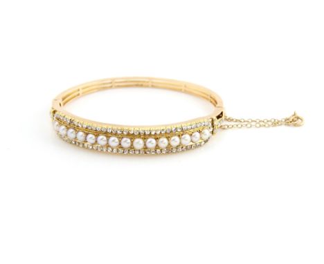 Victorian hinged bangle set with half pearls and rose cut diamonds, the sides with trefoil detail, inside measurement, 5.7 cm