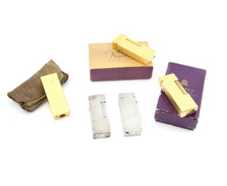 Five vintage Dunhill cigarette lighters, two matching gilt metal with engine turned cases, with two similar  silver plated ex