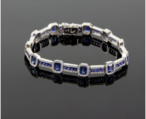 Sapphire and diamond bracelet, set with eleven rectangular step cut sapphires, each surrounded by round brilliant cut diamond