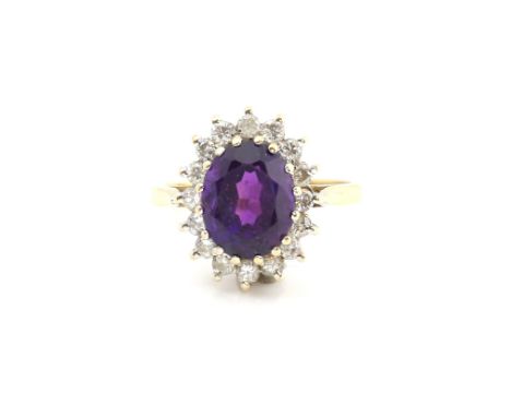 Vintage cluster ring, central set oval cut amethyst, within a round brilliant cut diamond border, mounted in 9 ct gold, hallm