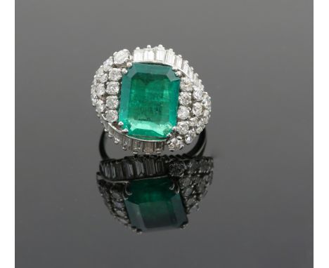 Vintage emerald and diamond ring set with a large step cut emerald of 6.60 carats, and an asymmetric arrangement of baguette 