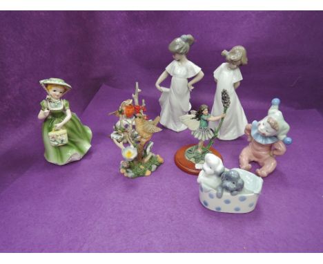 Four Nao figurines and studies, Girl in white dress 1100, Girl in white dress 1110, two dogs in a basket and Young Clown, two