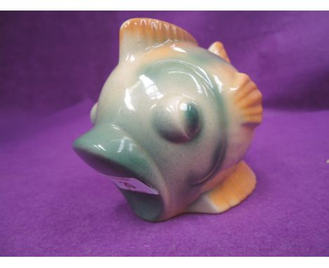 A vintage ceramic money box in the form of a stylised fish