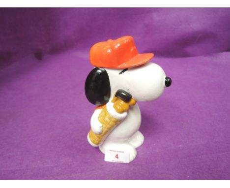 A vintage ceramic figure of Snoopy dog as golf caddy stamped 1958,1966 
