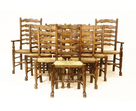 A matched set of ten Lancashire ladder back chairs, comprising two armchairs and eight singles, with rush seats