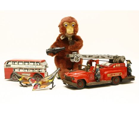 A tin plate clockwork toy bus, together with a tin plate fire engine, two finches, and a clockwork 'clapping monkey'