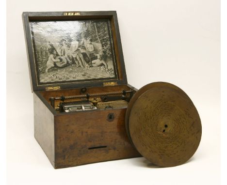 A mahogany cased Symphonion with one comb and six discs
