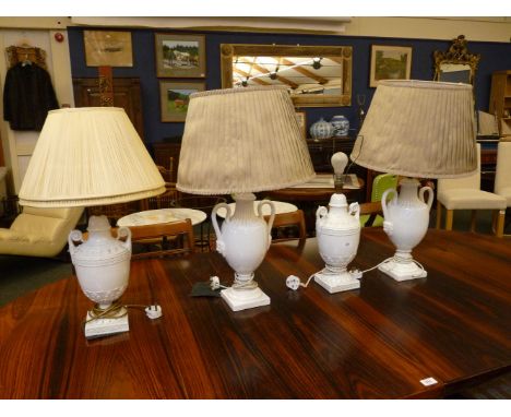 A pair of blanc de chine porcelain table lamps, of classical urn form, 41cm high, and a similar lamp (4)