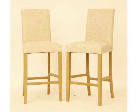 A pair of John Lewis bar stools, light finish wood with seats and backs upholstered in beige fabric