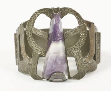 A 1974 triangular cabochon amethyst bangle with pierced top section, worked bark and scale textured decoration, London 1974 S