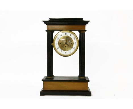 A 19th century French ebonised portico clock, with an enamel dial, no pendulum, 48cm high