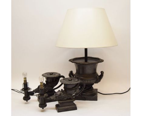 A pair of neo classical table lamps, in the form of ancient Roman oil lamps with boars head terminal, together with a table l