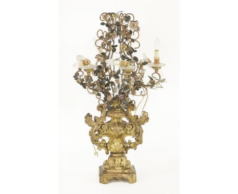 An Italian giltwood table lamp,20th century, surmounted with scrolling, pressed and painted metal flowering foliage,93cm high